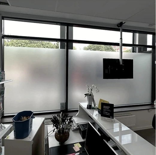 Frosted film installation on a reception area window
