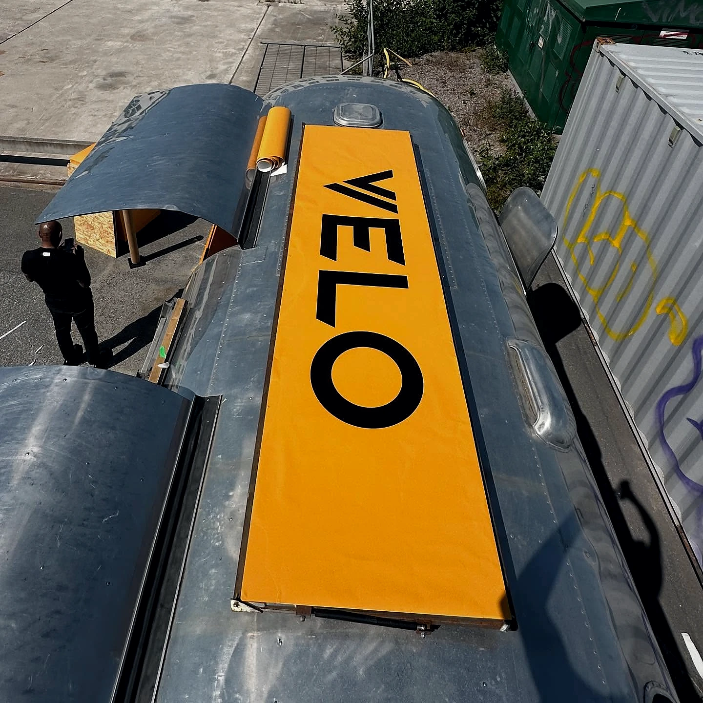 Large yellow VELO branding panel applied to a vehicle